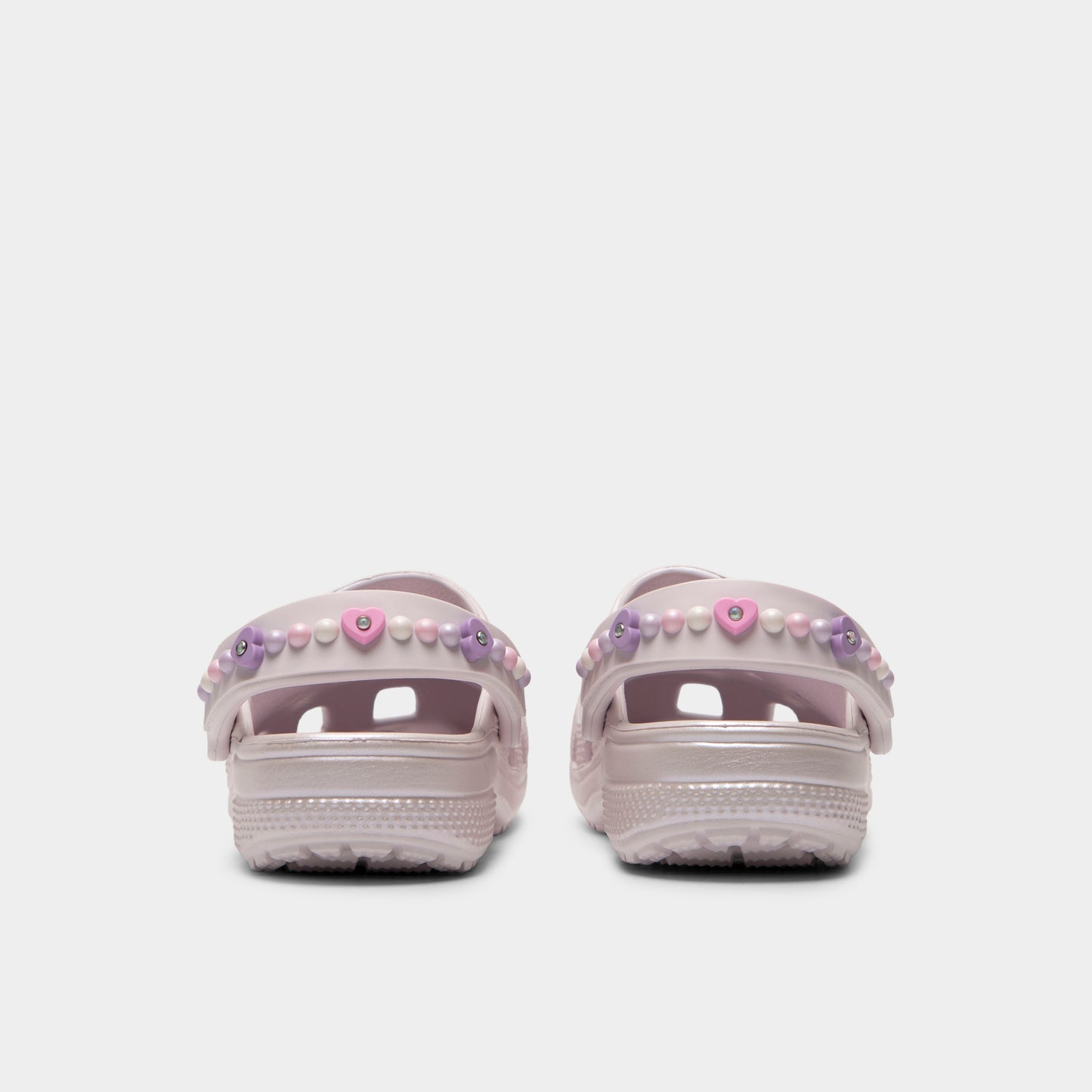 Crocs Kids' Classic Pearls and Heart Shine Clog. Rear view of grape ice infant clogs with lowered heel straps, rounded heels and matching soles.