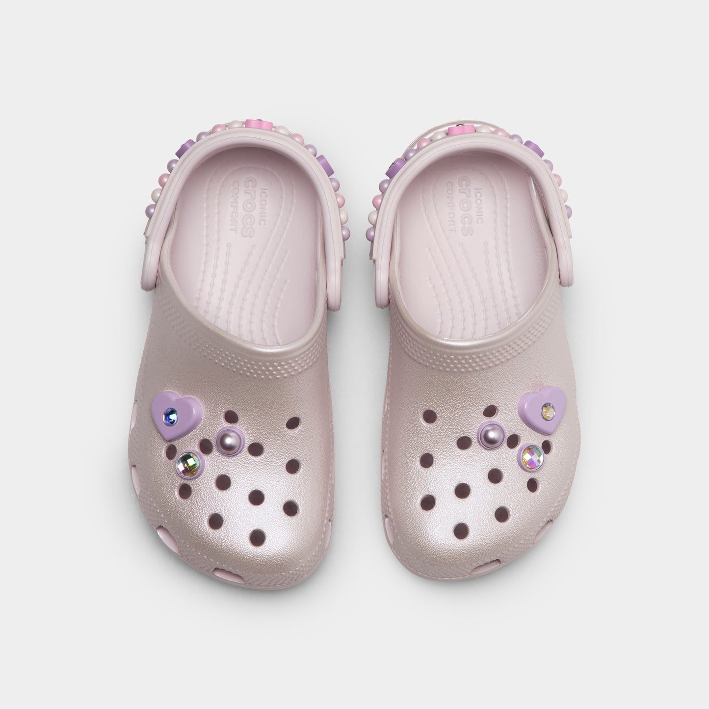 Crocs Kids' Classic Pearls and Heart Shine Clog. Top view of grape ice infant clogs showing ventilation holes, decorative charms and pivoting heel straps.