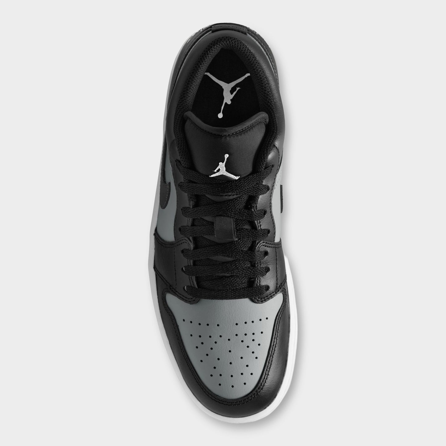 Jordan 1 Low. Top view of black, white and light smoke grey sneaker showing black laces, padded tongue and perforated white toe box.