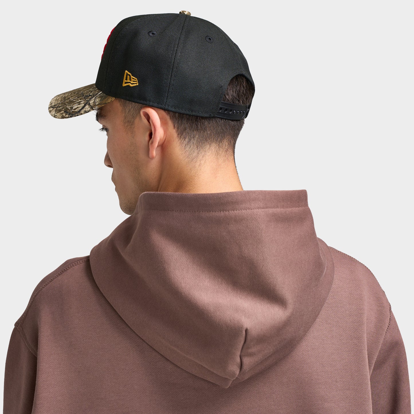 New Era Toronto Raptors 9FORTY AF Snapback. Back view of model wearing black and camo cap with adjustable snapback closure and structured crown.