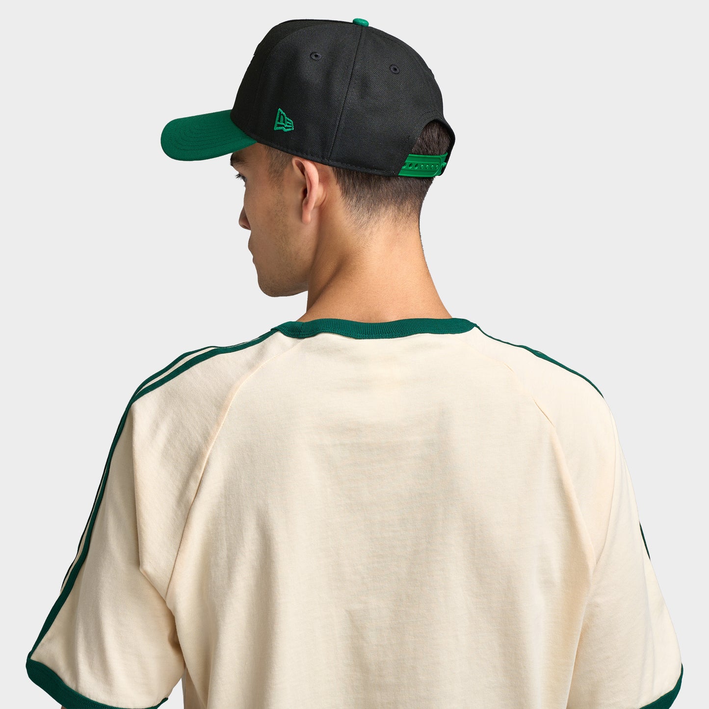 New Era Saskatchewan Roughriders 9FORTY AF. Back view of model wearing black and green cap with adjustable closure and structured crown.