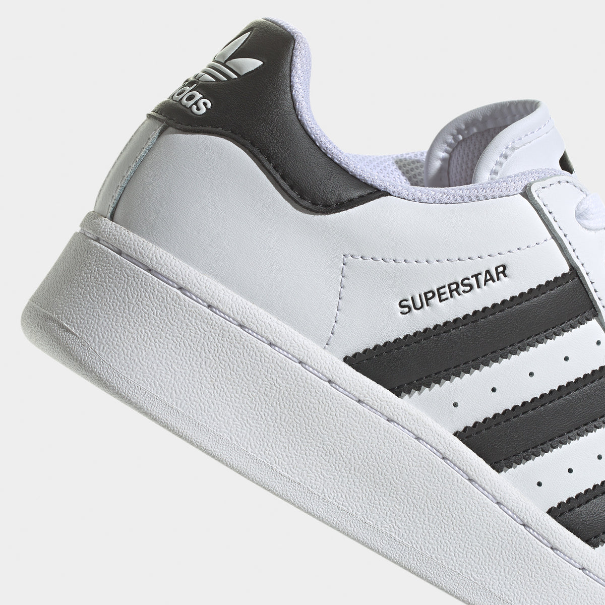 Black superstars with white stripes clearance
