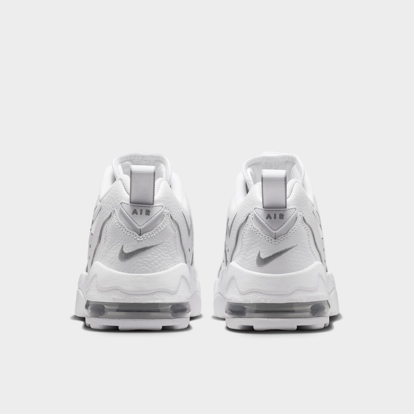 Nike Air DT Max '96 Low. Rear view of white and metallic silver sneakers with padded heel panels and layered soles.