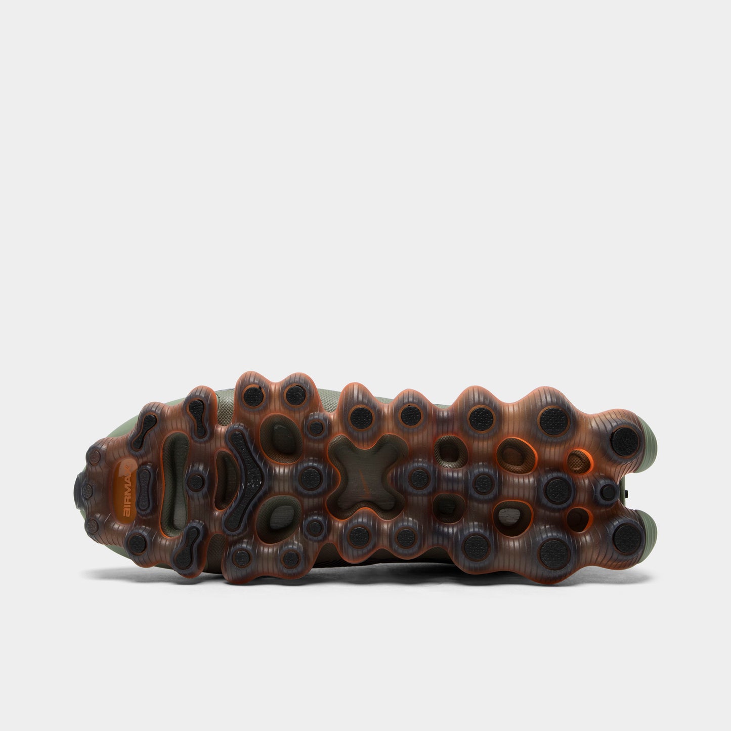 Nike Air Liquid Max. Bottom view of black, metallic silver and light army sneaker showing dark outsole with visible amber Air pod structure.