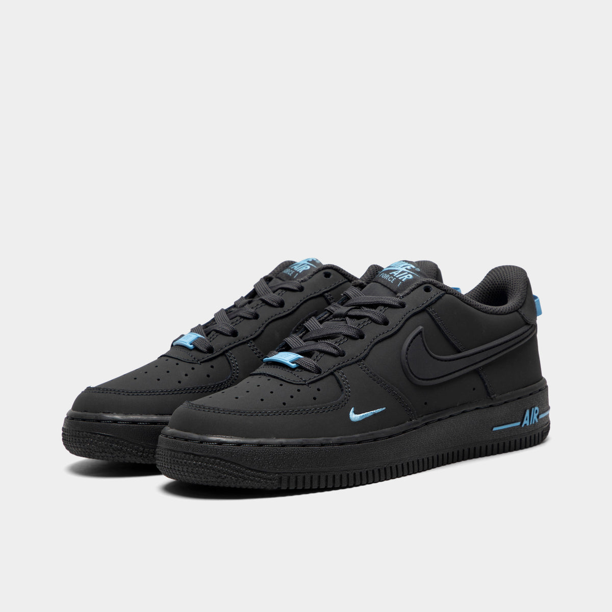 Nike Air Force 1 GS. Three-quarter view of pair of low-top sneakers showing anthracite leather uppers, tonal laces, football blue accents, and anthracite midsoles.