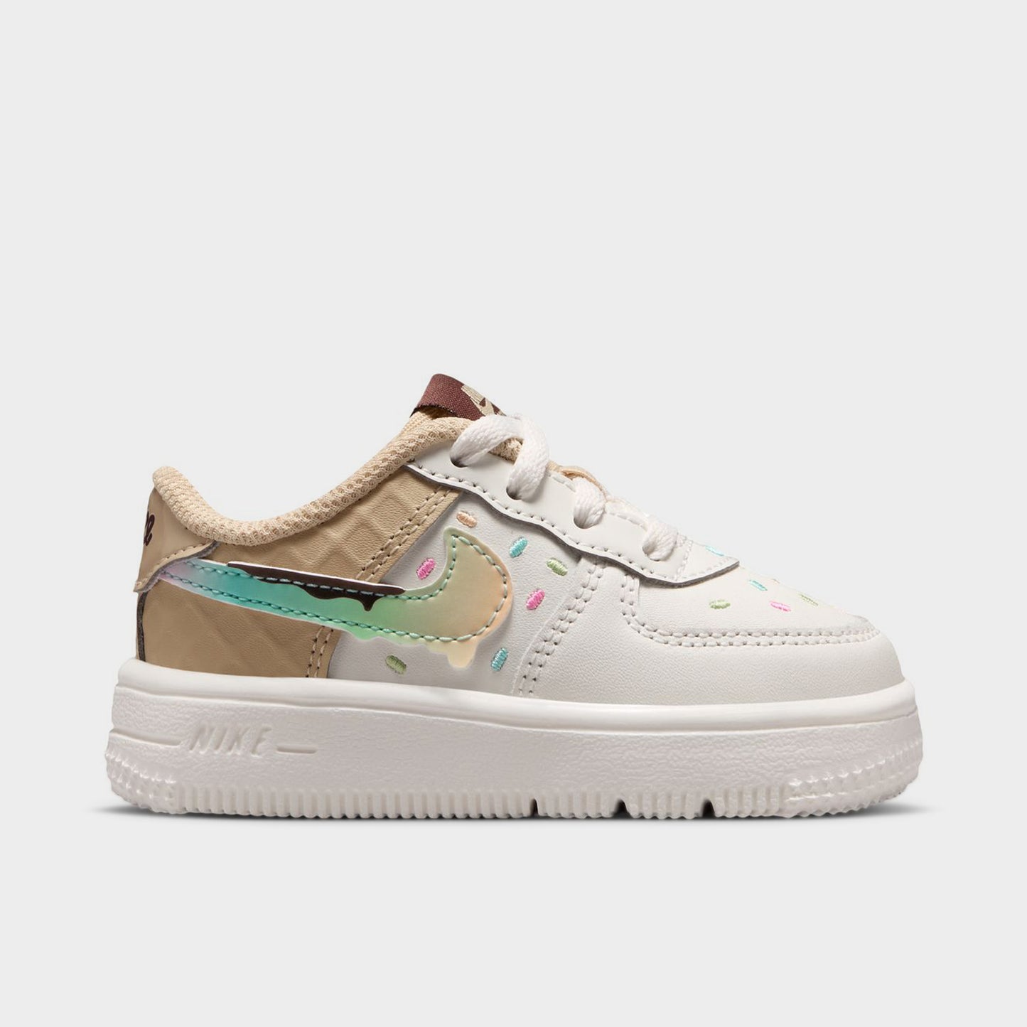 Nike Air Force 1 TD. Opposite side view of sail, multicolour and sesame toddler sneaker with pastel Swoosh, beige collar and white sole.