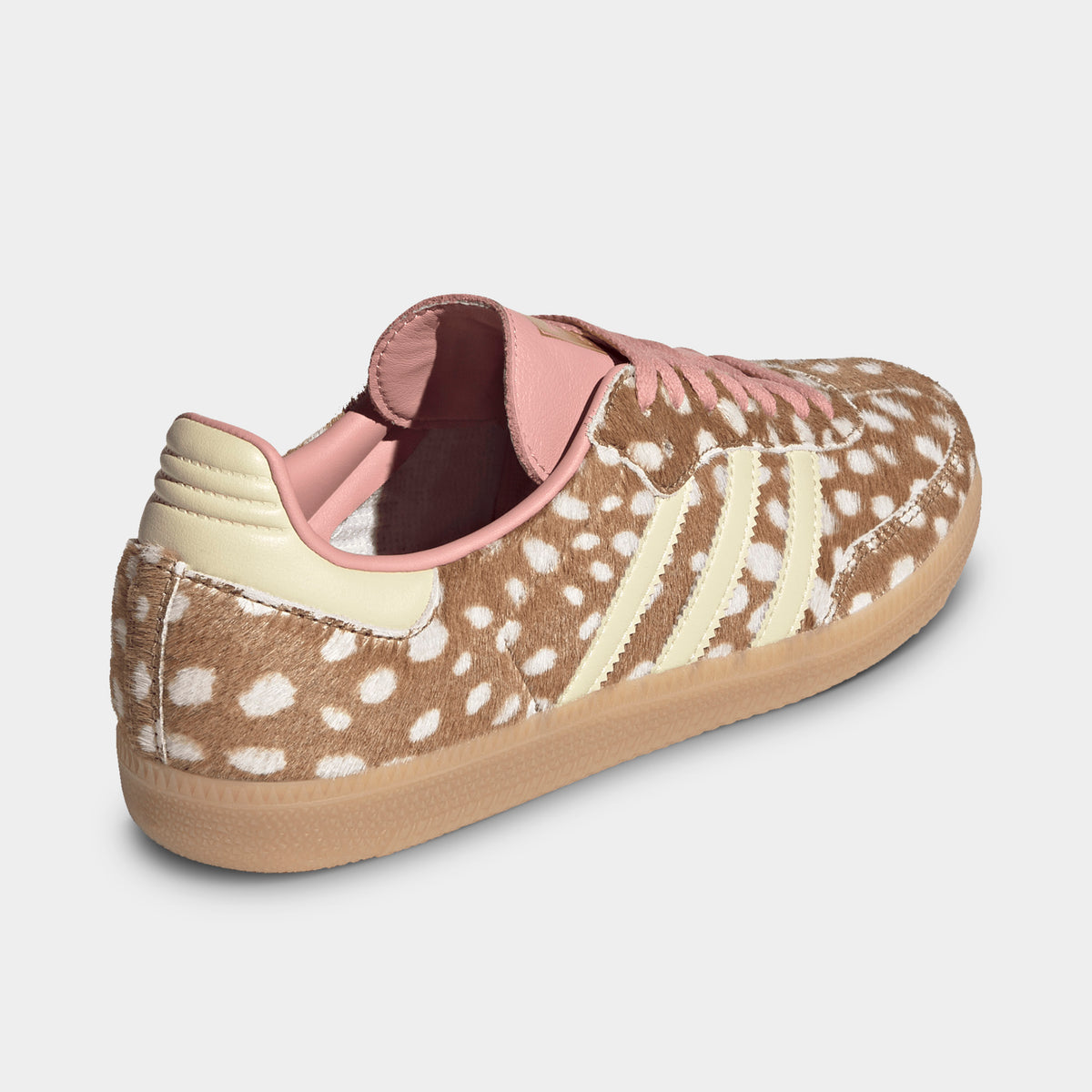 adidas Originals Women's Samba OG. Three-quarter rear view showing the spotted cow-print ponyhair heel counter, warm vanilla leather heel tab, dusty pink collar lining, and gum rubber outsole.