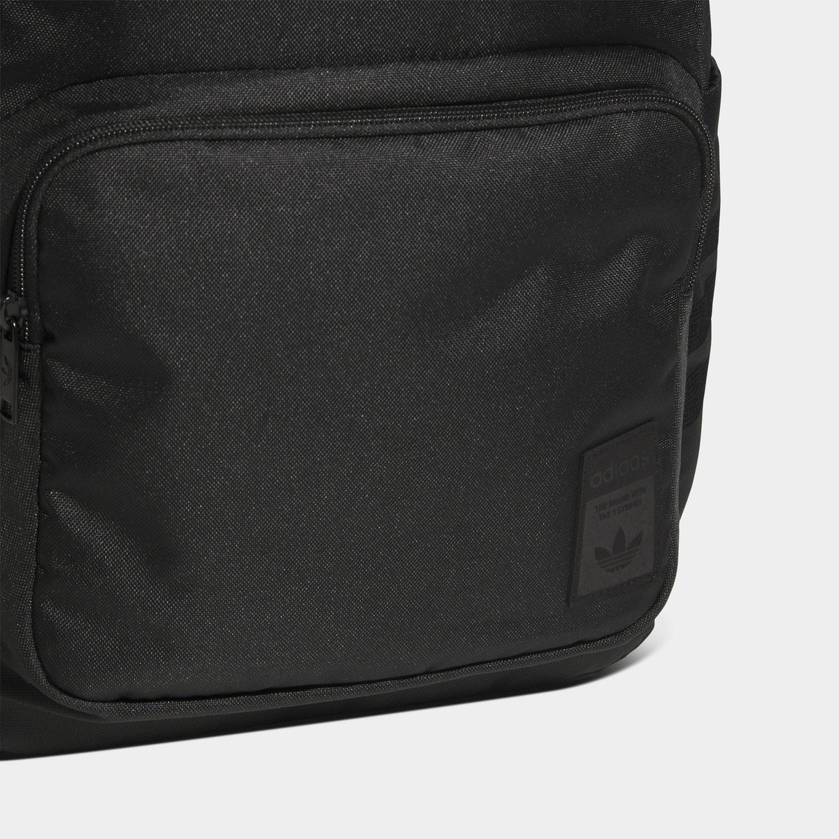 adidas Premise 2.0 Backpack. Close-up of black backpack showing smooth fabric panel, stitched seams and tonal finish.