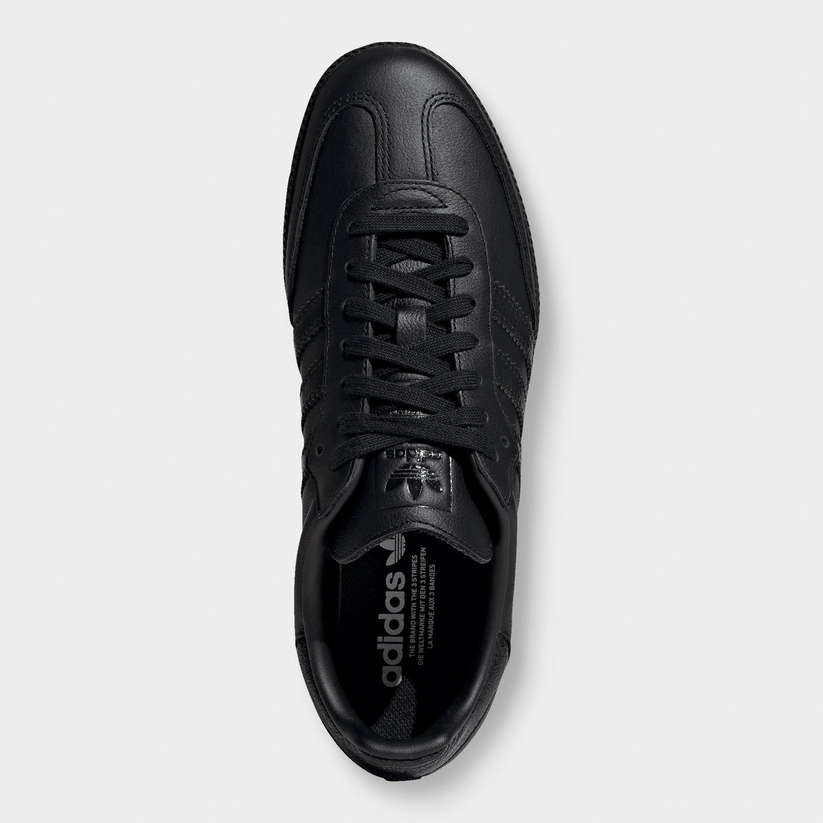 adidas Samba OG. Top view of black sneaker showing black laces, padded tongue and dark insole.