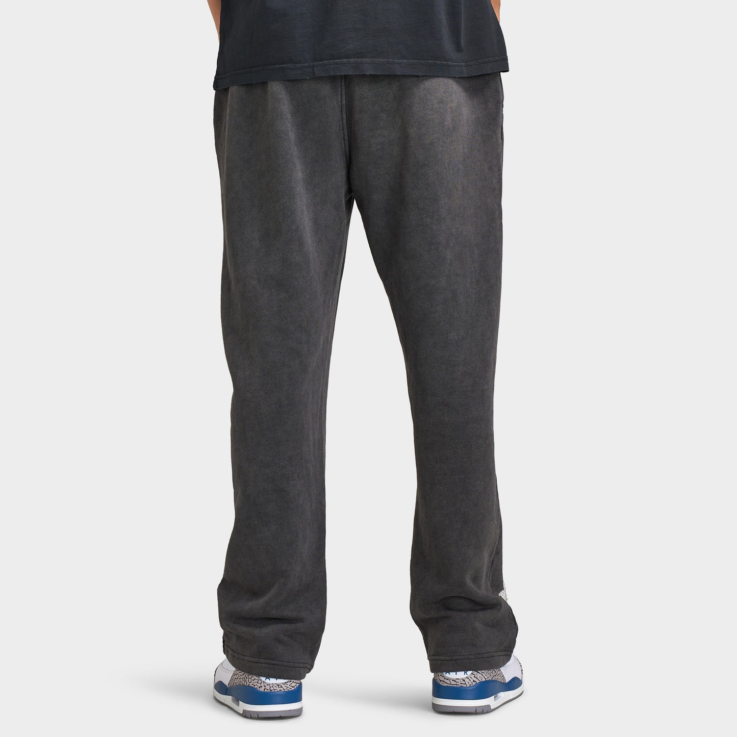 Supply & Demand Murphy Oversized Pants. Back view of model wearing black oversized pants with wide legs, relaxed fit and plain rear panels.