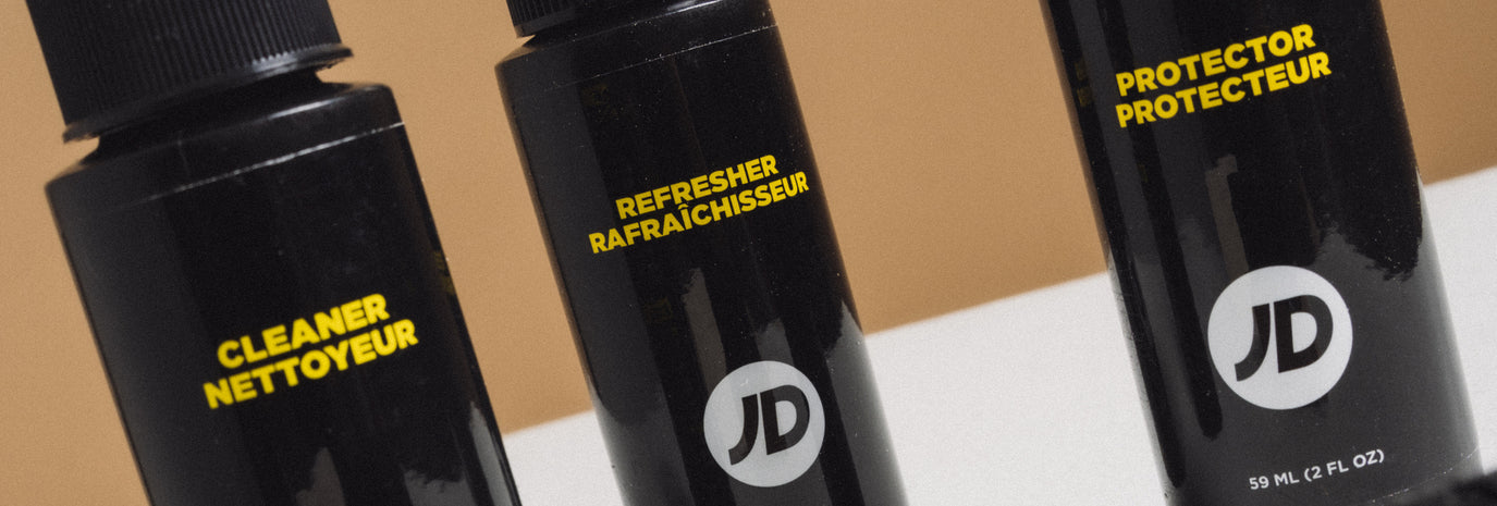 JD Shoe Care Products lined up on a table. Our Cleaner, Refresher & Protector