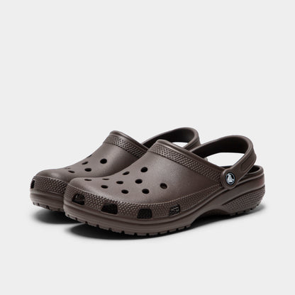 Crocs Classic Clog. Three-quarter view of espresso clogs with ventilation holes, raised heel straps and rounded toes.