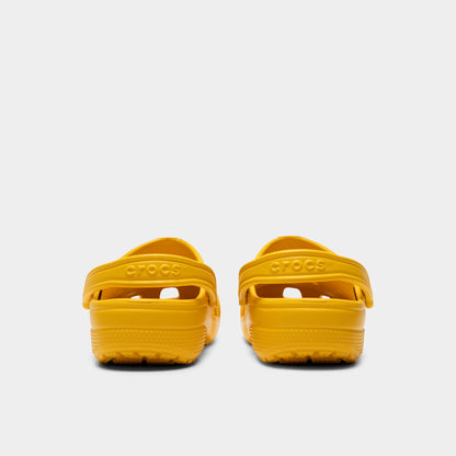 Crocs Classic Clog. Rear view of golden light clogs with lowered heel straps, rounded heels and matching soles.