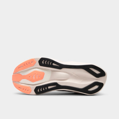 ASICS Novablast 6. Bottom view of black and khaki running shoe showing black and white segmented outsole with orange traction details.