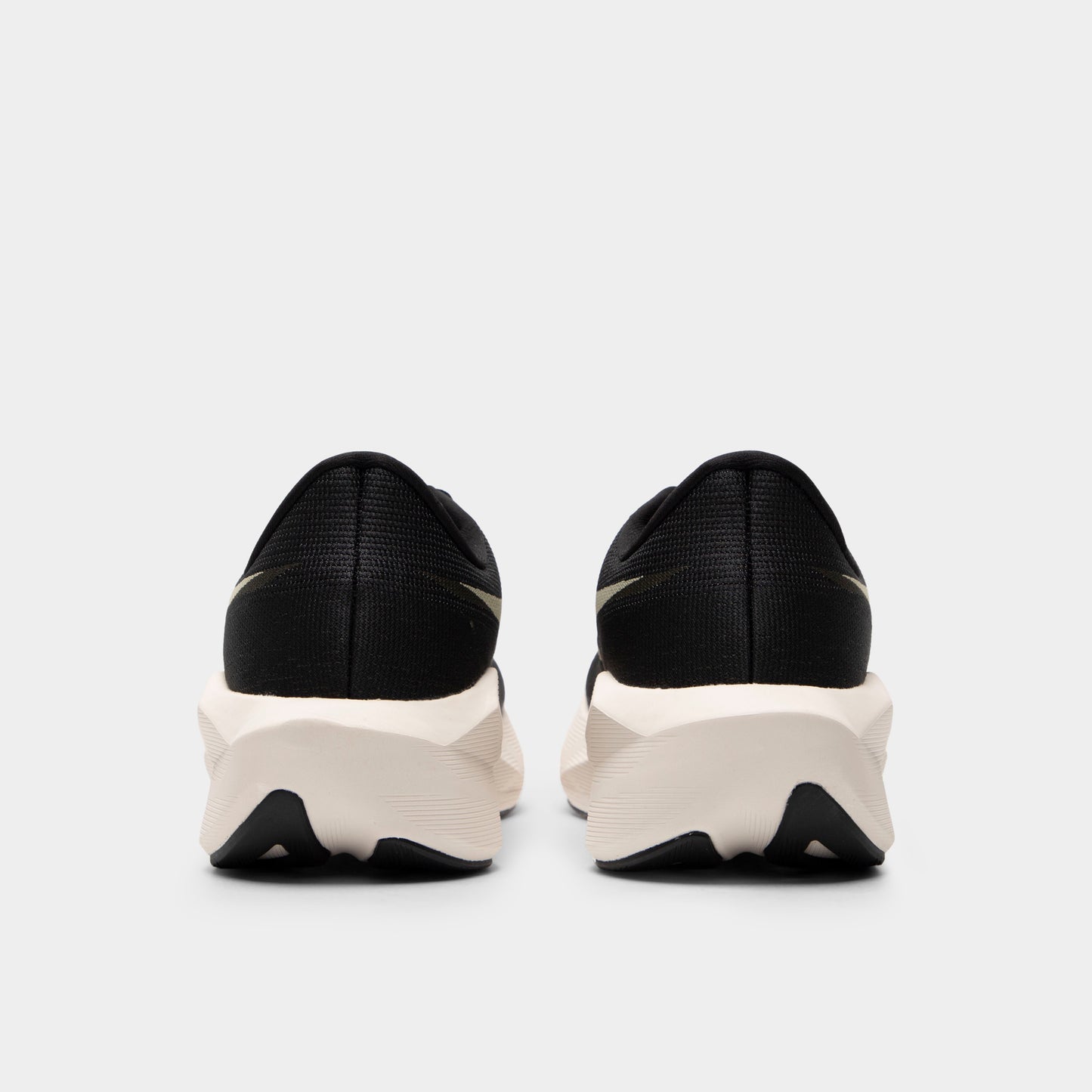 ASICS Novablast 6. Rear view of black and khaki running shoes with padded heel panels, white midsoles and black outsole sections.