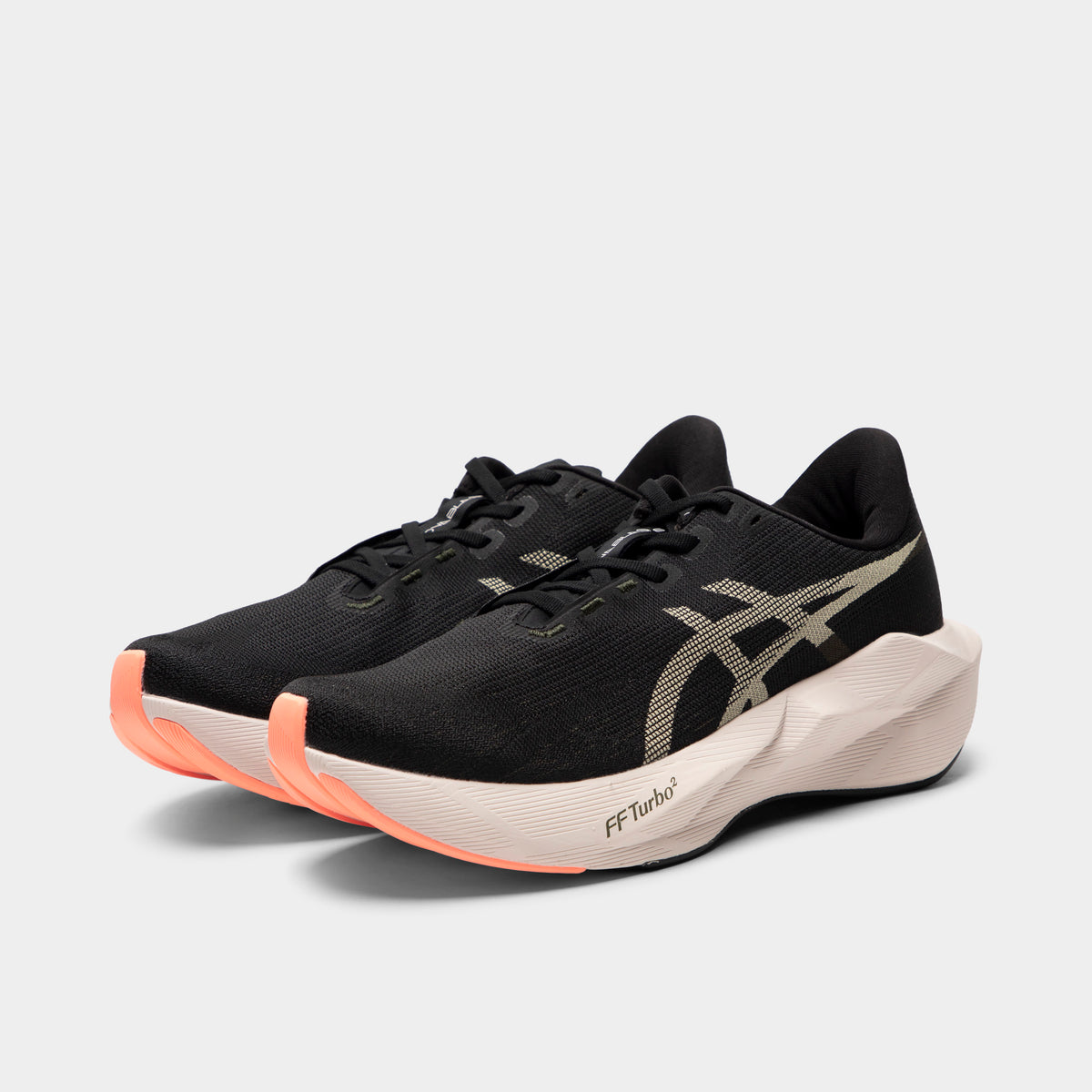 ASICS Novablast 6. Three-quarter view of black and khaki running shoes with black laces, layered uppers and orange forefoot accents.