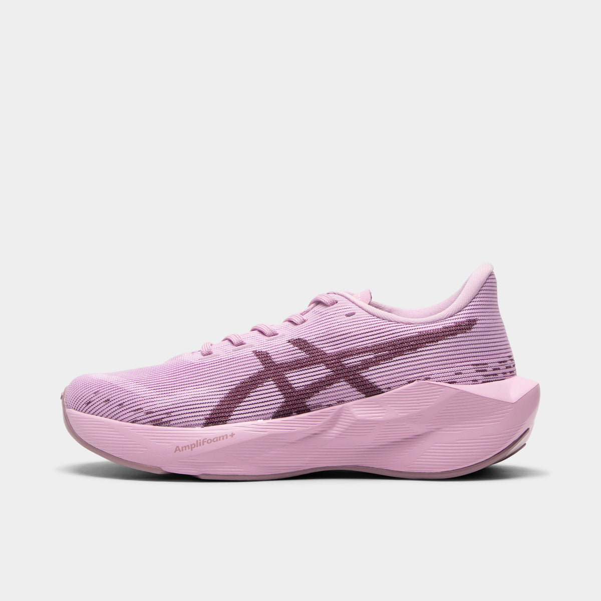 ASICS Juniors' Novablast 5. Side view of hazy lilac and dark prune junior running shoe with mesh upper, dark ASICS stripes and sculpted midsole.