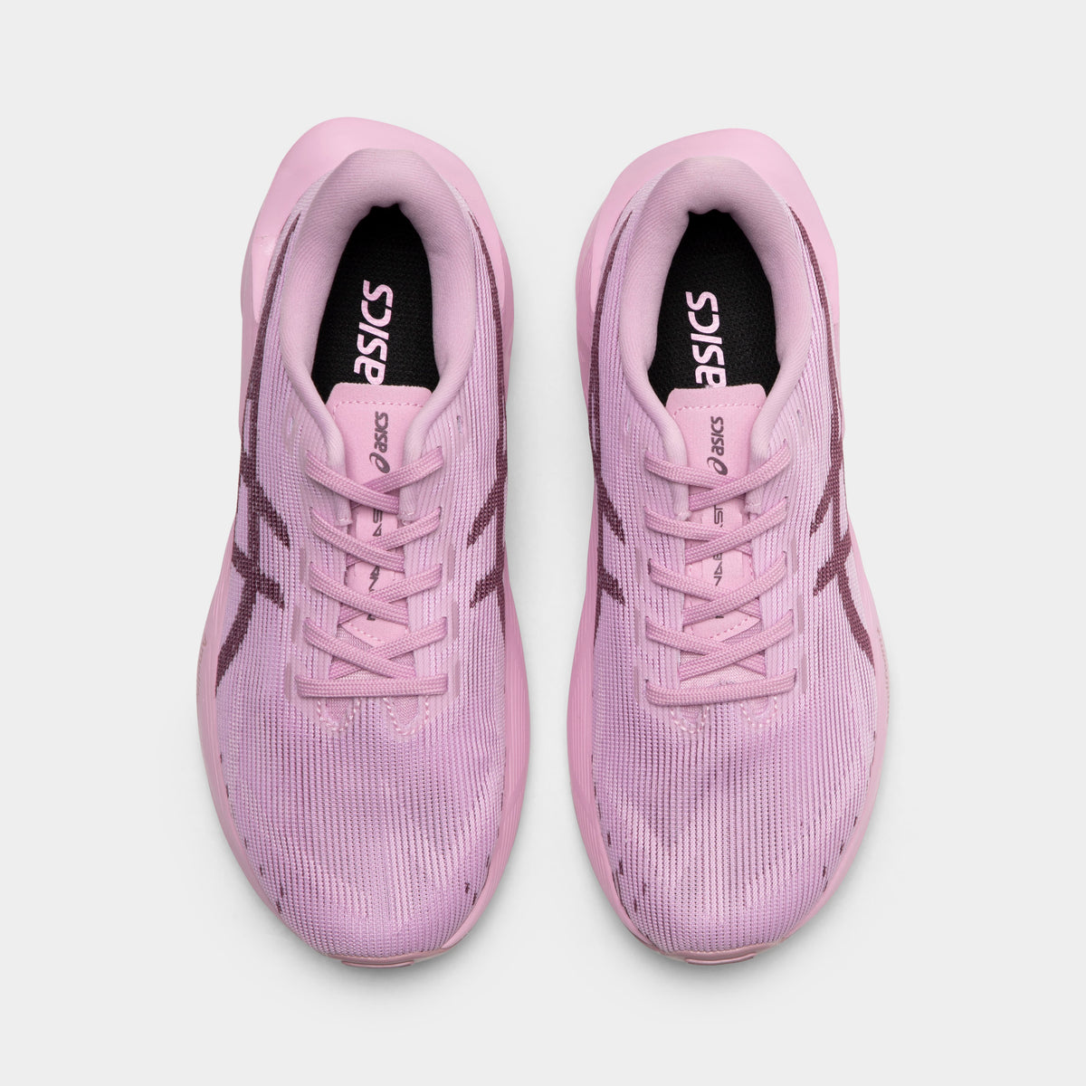 ASICS Juniors' Novablast 5. Top view of hazy lilac and dark prune junior running shoes showing tonal laces, padded tongues and mesh toe boxes.