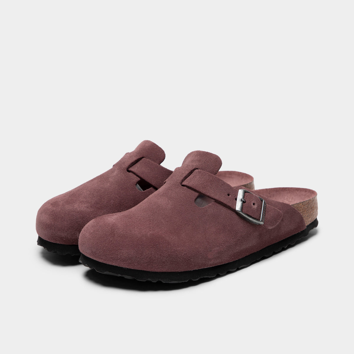 Birkenstock Women's Boston. Three-quarter view of pepper clogs with suede uppers, adjustable buckles and contoured cork footbeds.
