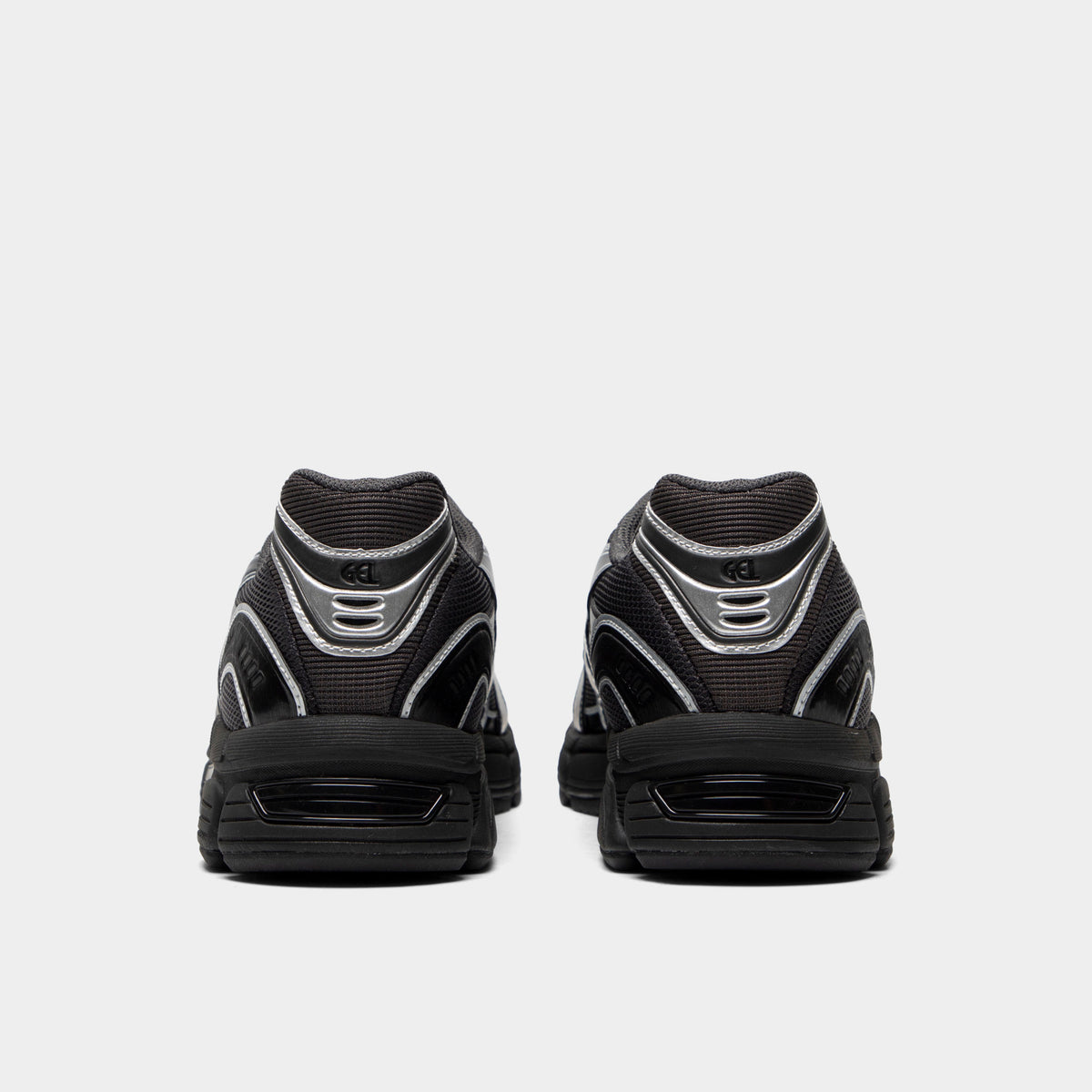 ASICS Gel-Stratus MC. Rear view of graphite grey and black sneakers with padded heel panels and black soles.
