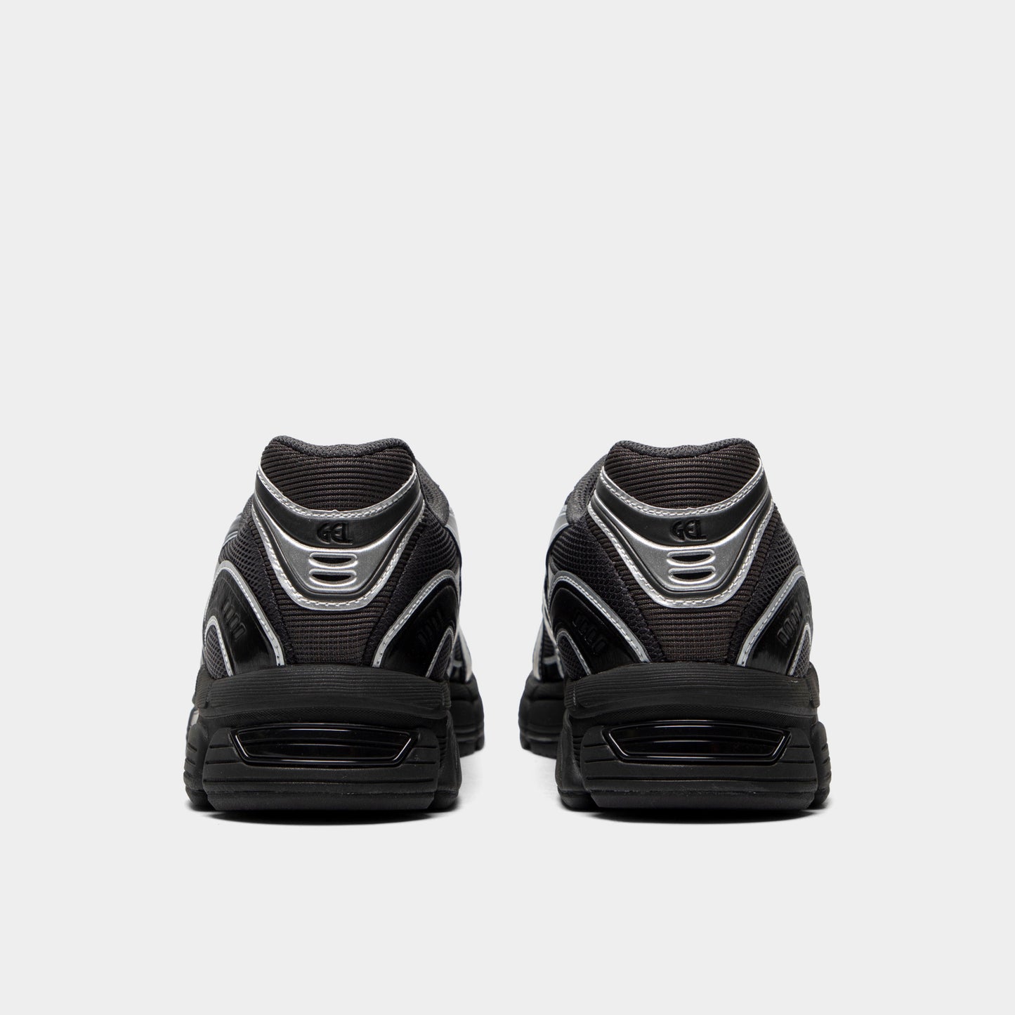ASICS Gel-Stratus MC. Rear view of graphite grey and black sneakers with padded heel panels and black soles.
