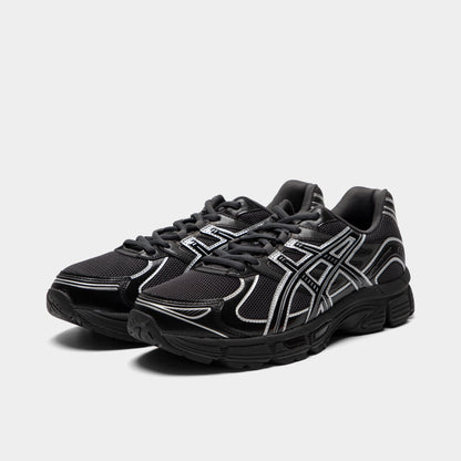 ASICS Gel-Stratus MC. Three-quarter view of graphite grey and black sneakers with black laces, layered overlays and tonal branding.