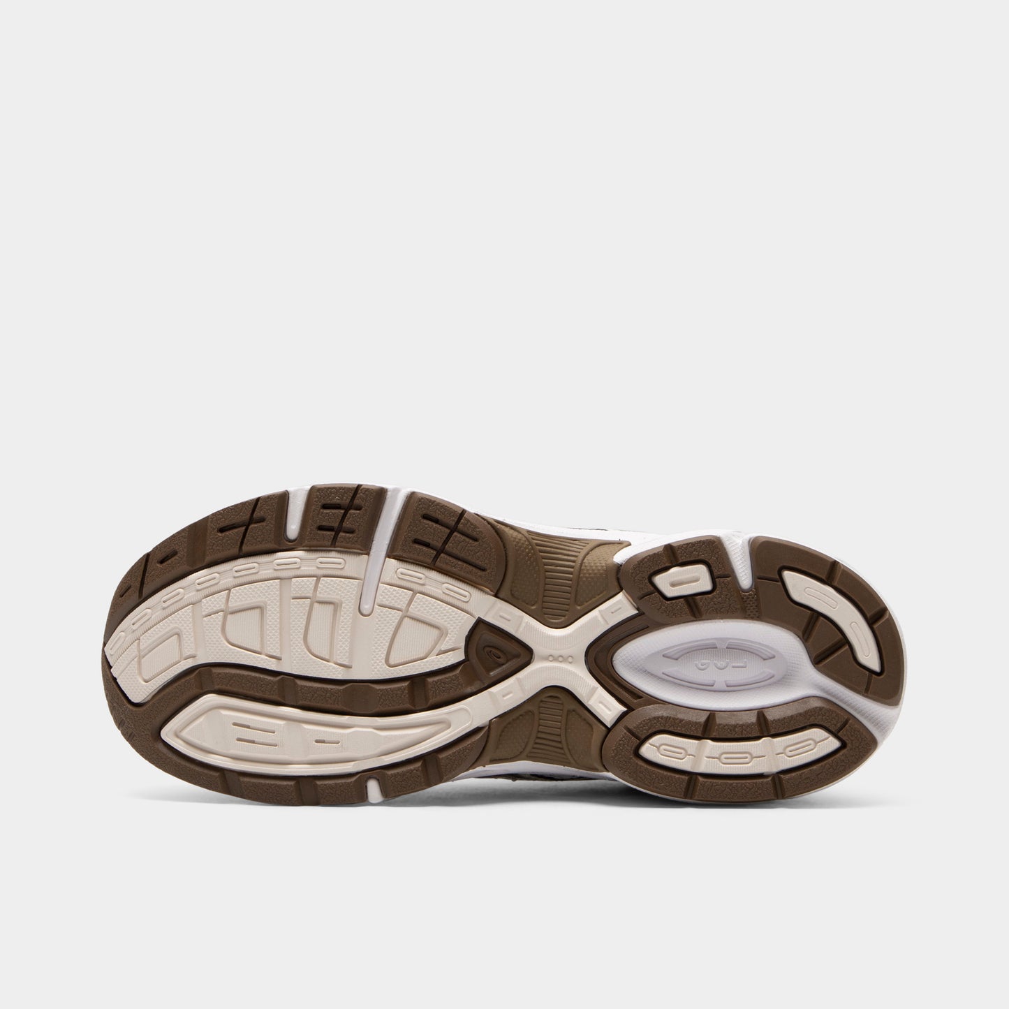 ASICS GEL-1130 GS. Bottom view of white and clay canyon sneaker showing brown and cream segmented outsole with textured tread pattern.