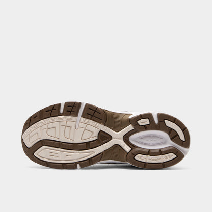 ASICS GEL-1130 GS. Bottom view of white and clay canyon sneaker showing brown and cream segmented outsole with textured tread pattern.