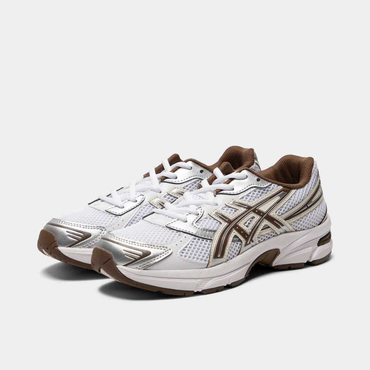ASICS GEL-1130 GS. Three-quarter view of white and clay canyon sneakers with white laces, layered overlays and brown ASICS branding.