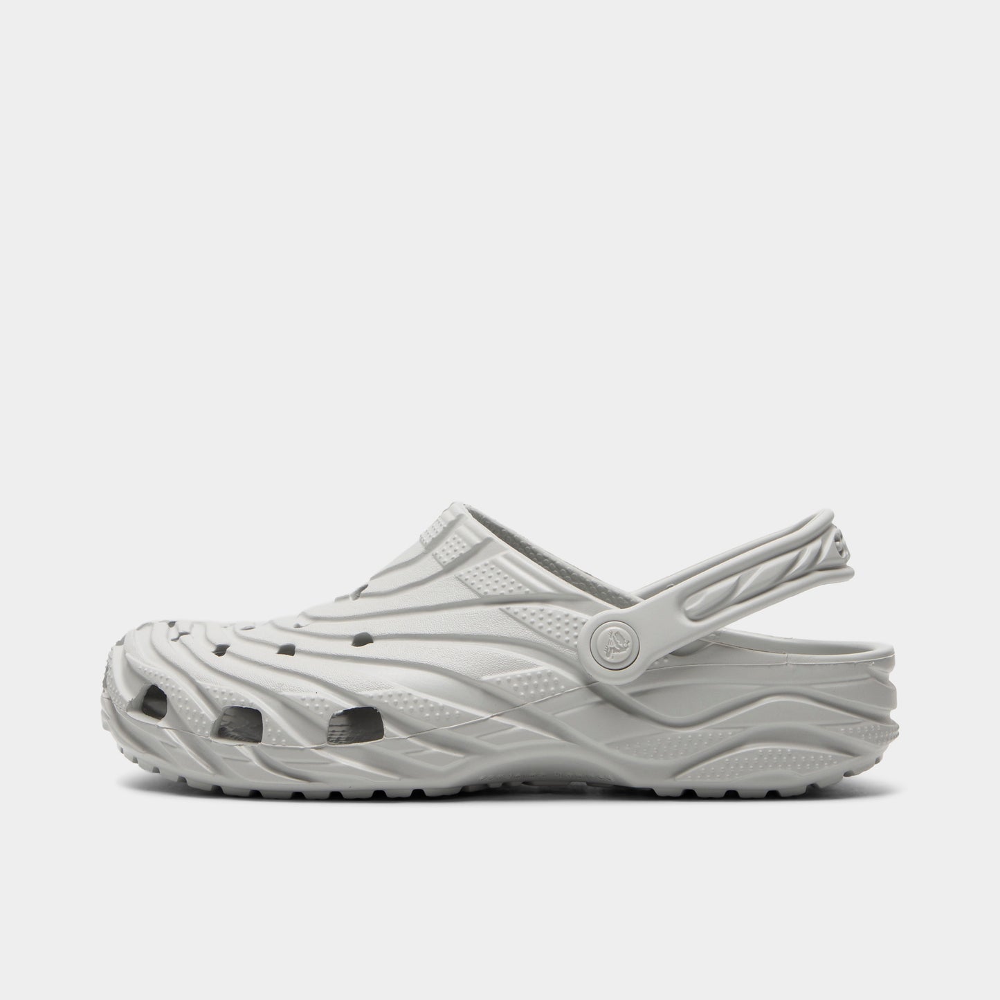 Crocs Classic Erosion Clog. Side view of atmosphere clog with sculpted wave-like upper, ventilation holes, pivoting heel strap and textured sole.