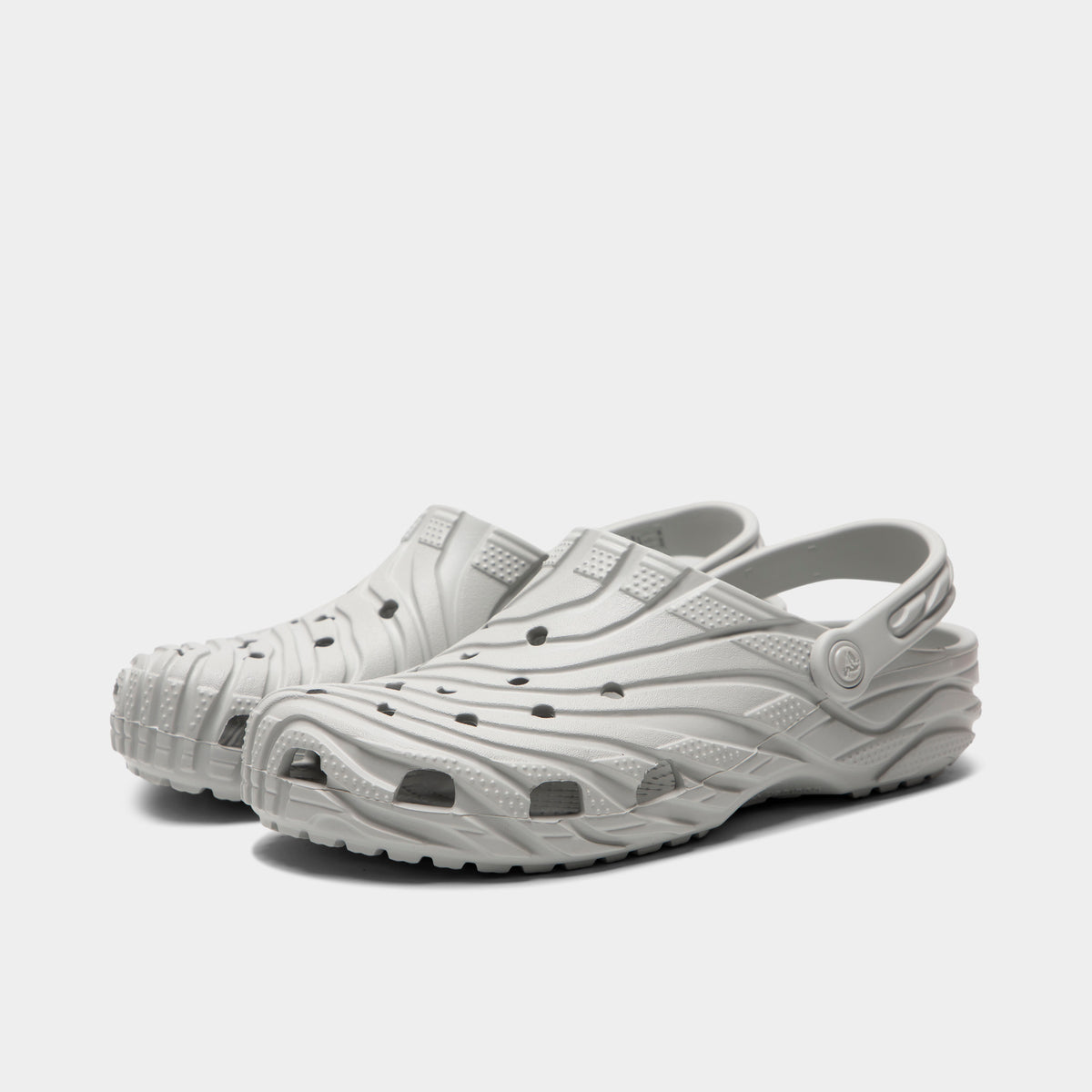 Crocs Classic Erosion Clog. Three-quarter view of atmosphere clogs with sculpted uppers, ventilation holes, raised heel straps and chunky soles.