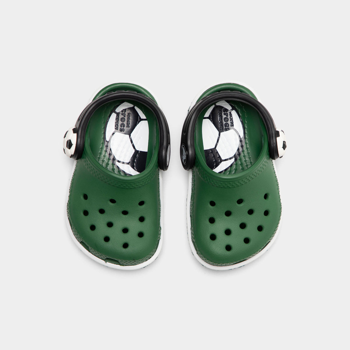 Crocs Infants' Classic Funlab Clog. Top view of turf green infant clogs showing ventilation holes, soccer ball details and pivoting heel straps.
