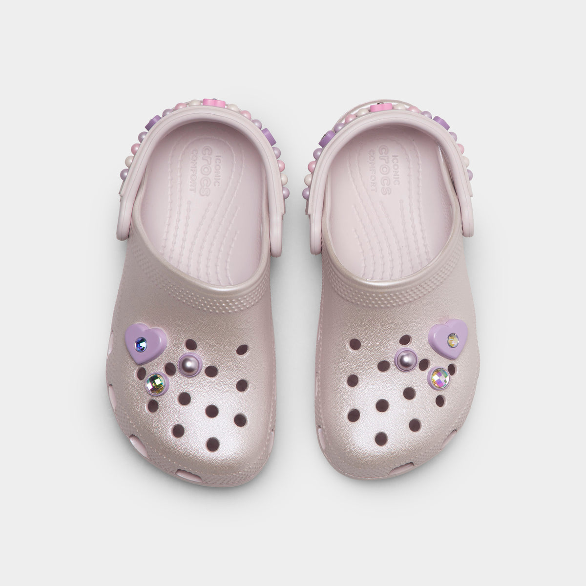 Crocs Kids' Classic Pearls and Heart Shine Clog. Top view of grape ice infant clogs showing ventilation holes, decorative charms and pivoting heel straps.