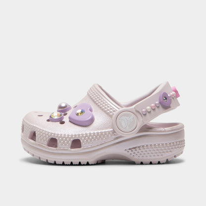 Crocs Infants' Classic Pearls and Heart Shine Clog. Side view of grape ice infant clog with ventilation holes, pivoting heel strap and decorative pearl and heart charms.