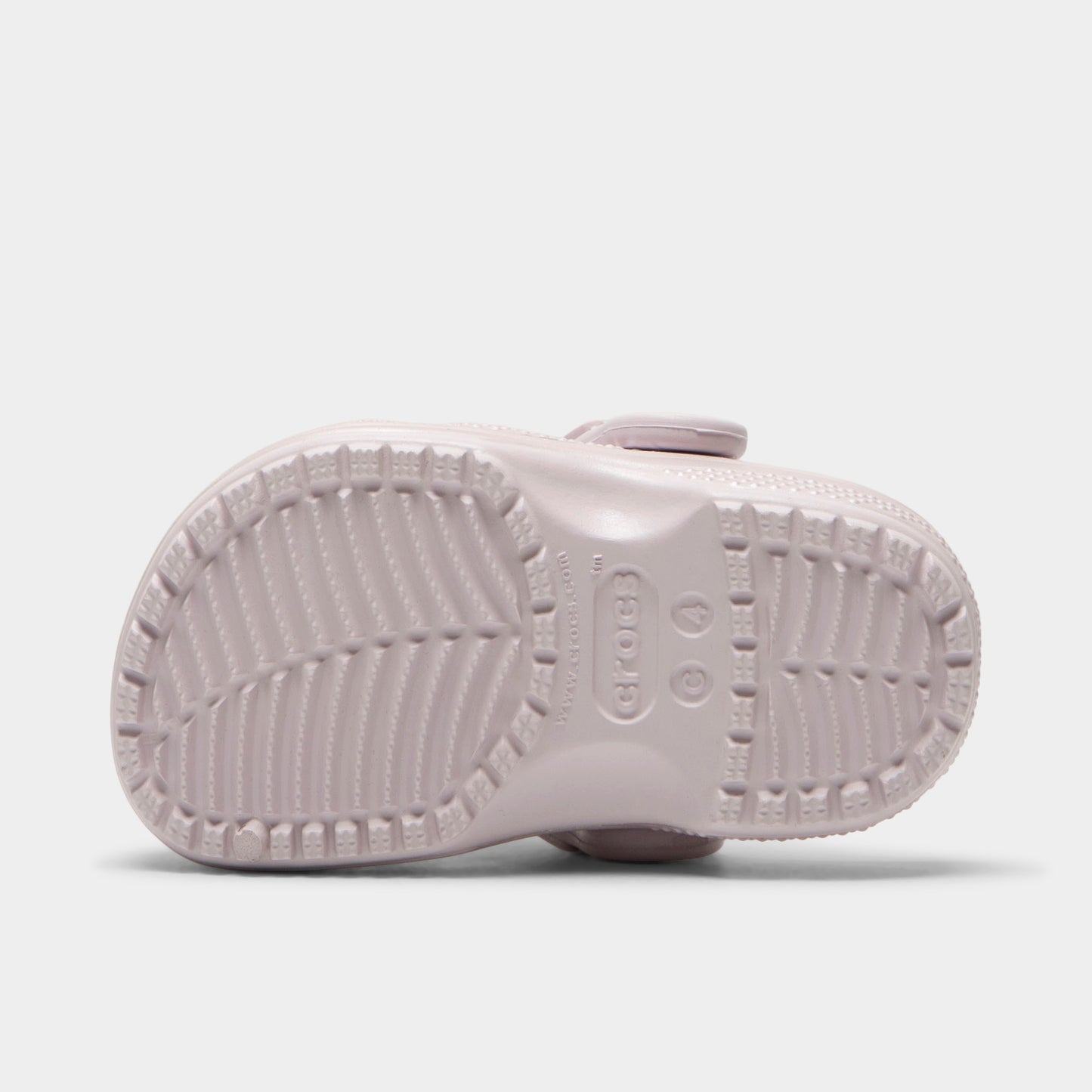 Crocs Infants' Classic Pearls and Heart Shine Clog. Bottom view of grape ice infant clog showing textured outsole with segmented tread pattern.