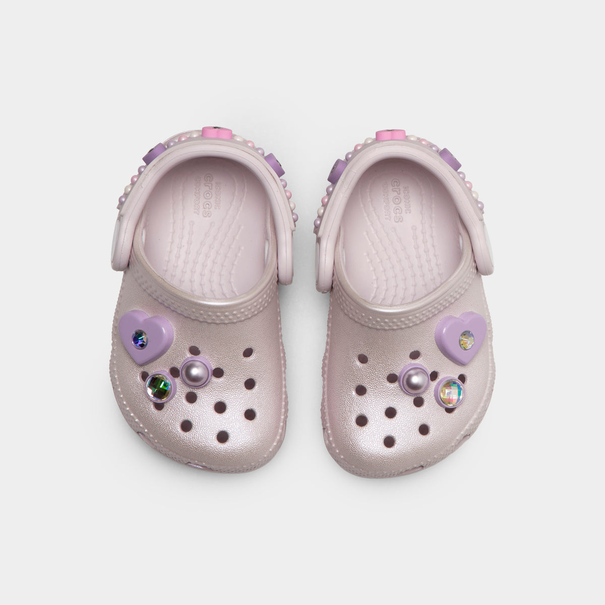 Crocs Infants' Classic Pearls and Heart Shine Clog. Top view of grape ice infant clogs showing ventilation holes, decorative charms and pivoting heel straps.