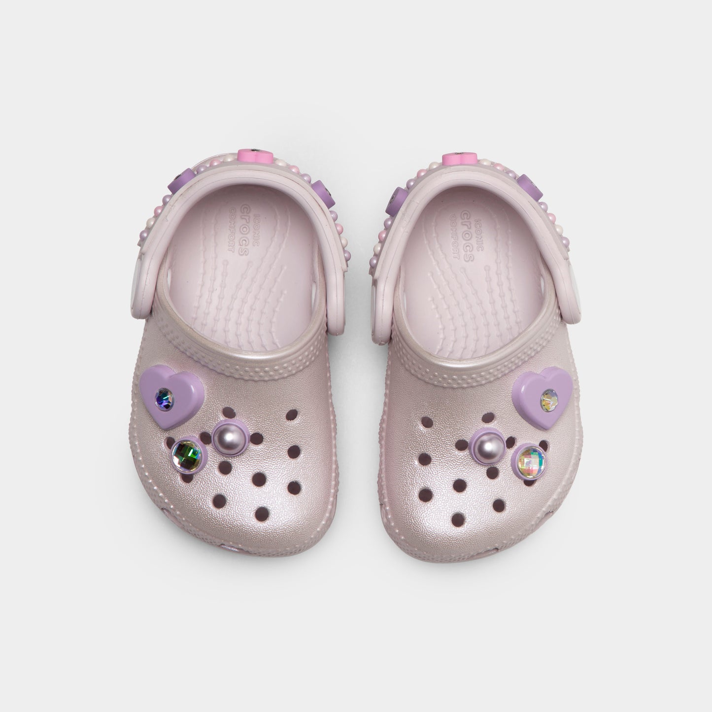 Crocs Infants' Classic Pearls and Heart Shine Clog. Top view of grape ice infant clogs showing ventilation holes, decorative charms and pivoting heel straps.