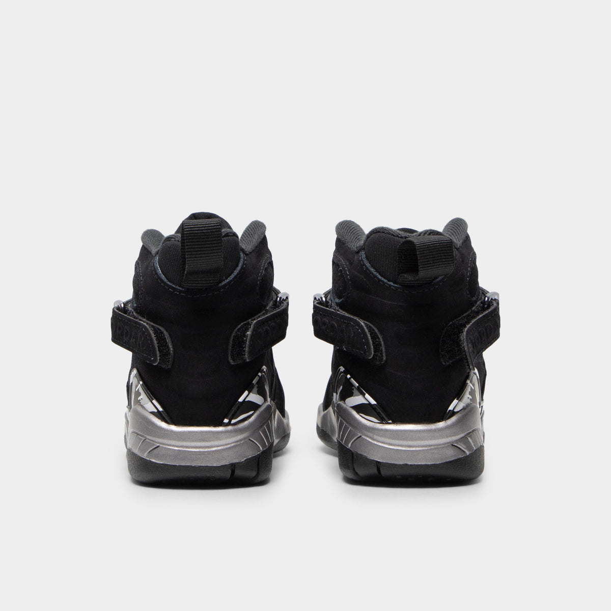 Jordan 8 Retro PS Black / White - Light Graphite. Rear view of the pair of black sneakers showing the heel pulls and Jordan branding