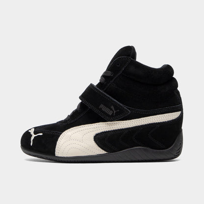 Puma Women's Speedcat Wedge. Side view of black and white wedge sneaker with white Formstrip, hook-and-loop strap and sculpted heel.