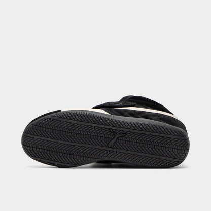 Puma Women's Speedcat Wedge. Bottom view of black and white wedge sneaker showing black outsole with textured tread pattern.