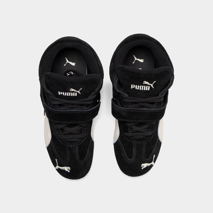 Puma Women's Speedcat Wedge. Top view of black and white wedge sneakers showing padded tongues, hook-and-loop straps and black insoles.