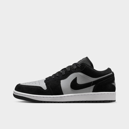 Jordan 1 Low. Side view of black, white and light smoke grey sneaker with black overlays, grey Swoosh and white midsole.