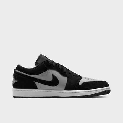 Jordan 1 Low. Opposite side view of black, white and light smoke grey sneaker with layered panels, grey Swoosh and white midsole.