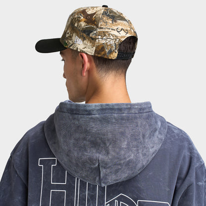 New Era Las Vegas Raiders 9FORTY A-Frame cap. Back view of model wearing the Realtree camo and black cap with curved brim and adjustable rear fit.
