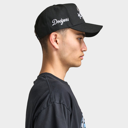 New Era LA Dodgers Shohei 9FORTY AF Snapback. Side view of model wearing black cap with curved brim, white side embroidery and structured profile.