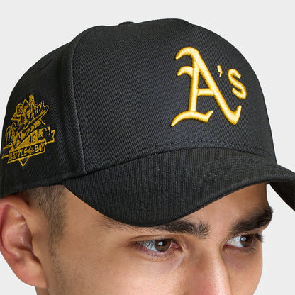 New Era Oakland Athletics 9FORTY AF Snapback. Close-up of black cap showing the gold Oakland Athletics logo, curved brim and gold side embroidery.