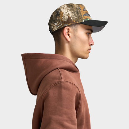 New Era Detroit Tigers 9FORTY AF. Side view of model wearing real tree camo and black cap with curved brim, camouflage crown and structured profile.