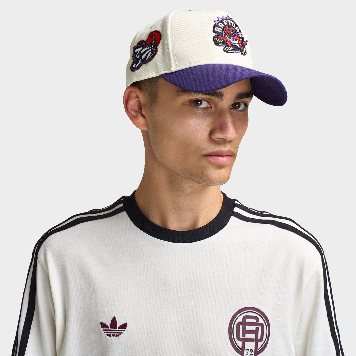 New Era Toronto Raptors 9FORTY AF. Front view of model wearing chrome and purple cap with curved purple brim, Toronto Raptors logo and side patch.