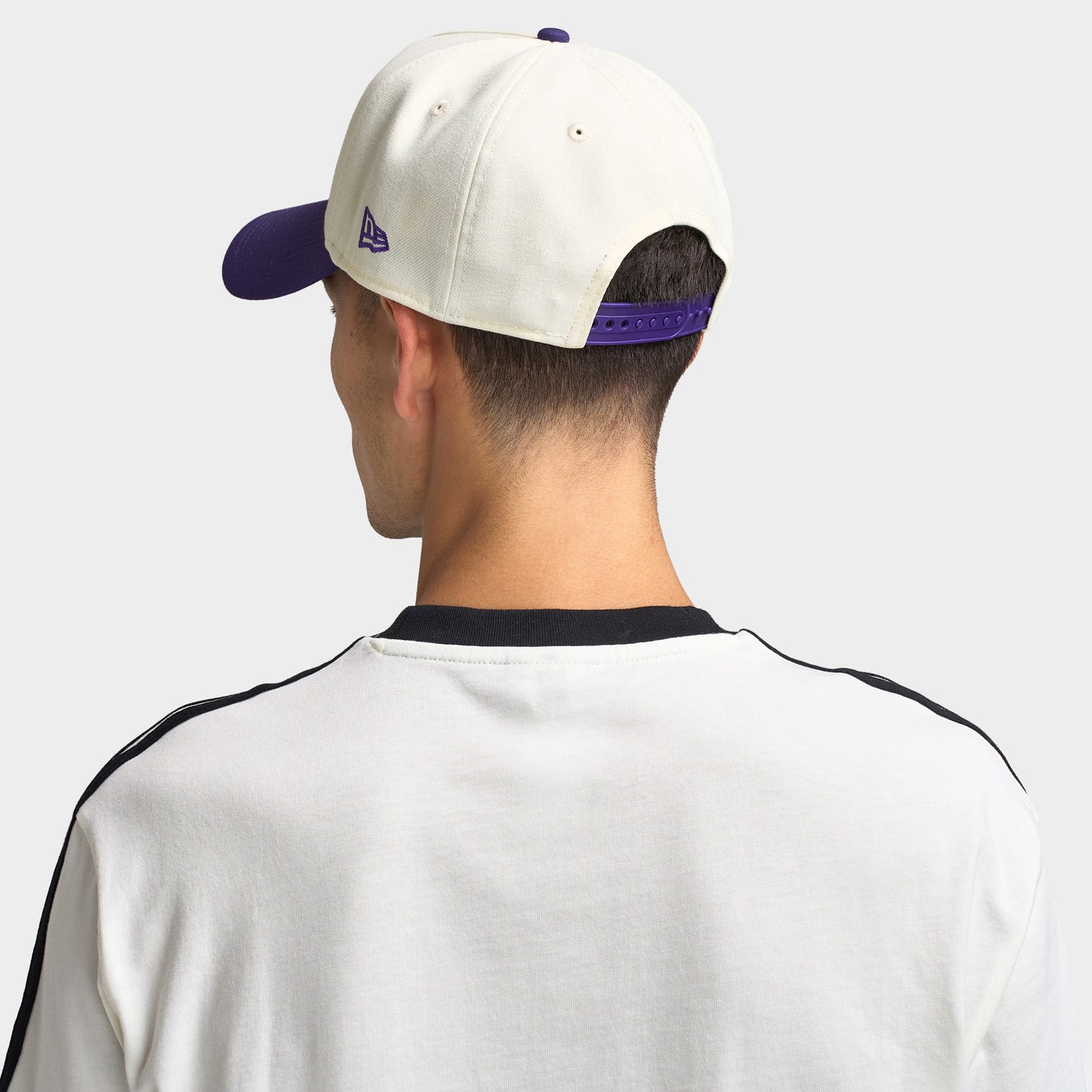 New Era Toronto Raptors 9FORTY AF. Back view of model wearing chrome and purple cap with adjustable closure and structured crown.
