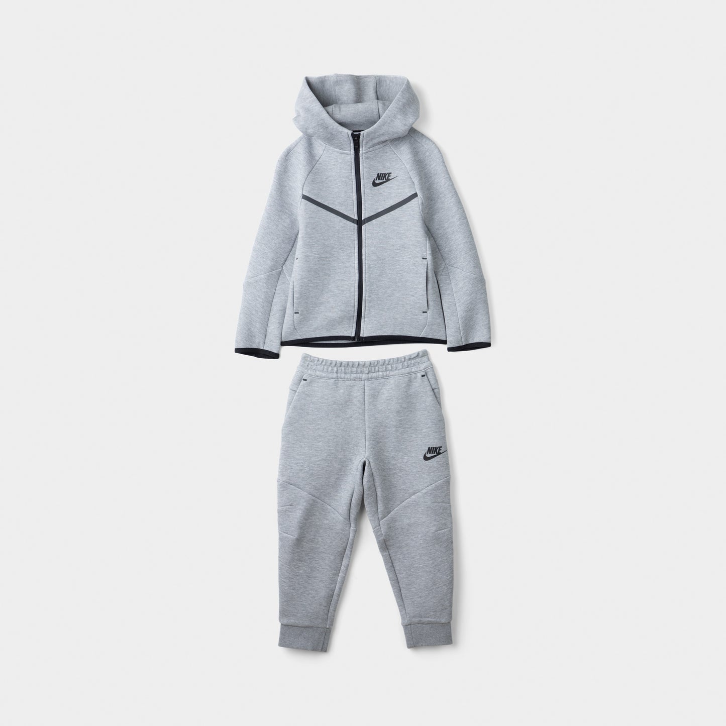 Nike Sportswear Children's Tech Fleece Full Zip Hoodie Set. Front view of dark grey heather hoodie and jogger set with black trim and Nike branding.